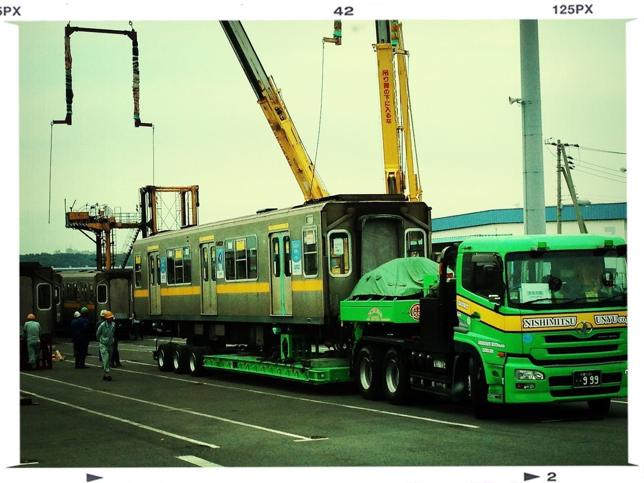 transportation, mode of transport, land vehicle, public transportation, transfer print, car, railroad track, train - vehicle, clear sky, rail transportation, yellow, built structure, architecture, street, building exterior, travel, auto post production filter, outdoors, road, in a row