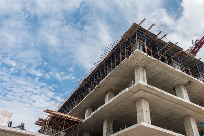 Low angle view of building against cloudy sky