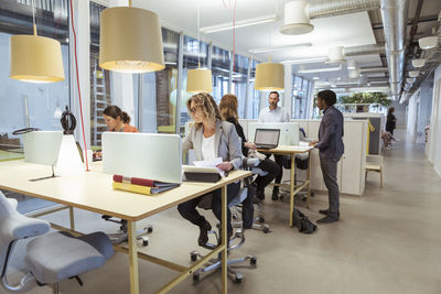 Multi-ethnic business people working at desk in office