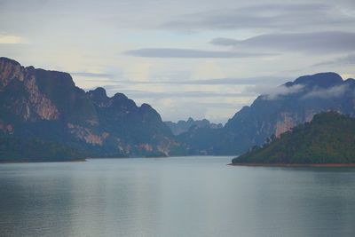 Scenic view of sea and mountains against sky