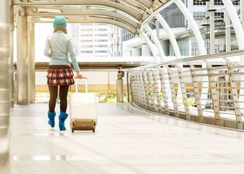 Full length rear view of man walking in corridor