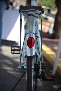 Close-up of red bicycle on road