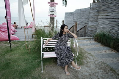 Portrait of young woman standing in park
