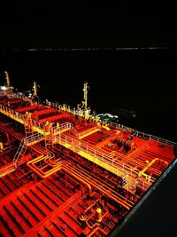 High angle view of illuminated city against sky at night