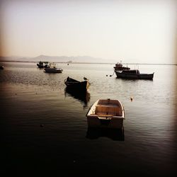 Boat moored in sea against sky