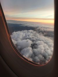 Scenic view of clouds seen through airplane window