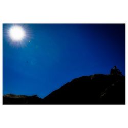 Scenic view of mountains against blue sky