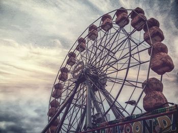 Low angle view of ferris wheel against sky