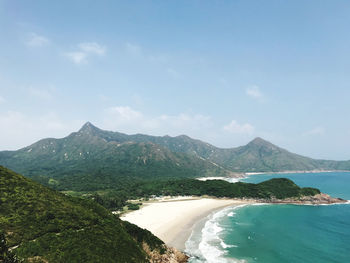 Scenic view of sea and mountains against sky