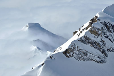 Scenic view of snow covered mountains against sky