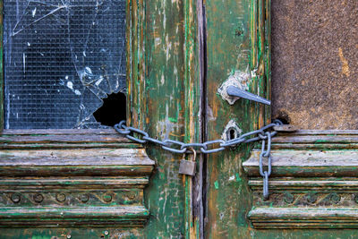 Padlock with chain on abandoned door