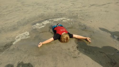 High angle view of young woman on beach