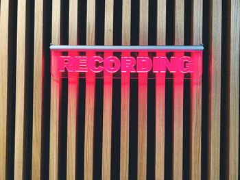 Close-up of text on metal railing