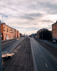 View of railroad tracks in city against sky