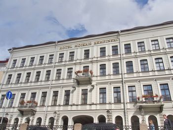 Low angle view of building against cloudy sky