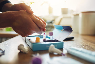 Close-up of person playing guitar on table
