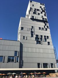 Low angle view of modern building against clear blue sky