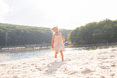 Portrait of young woman standing at beach