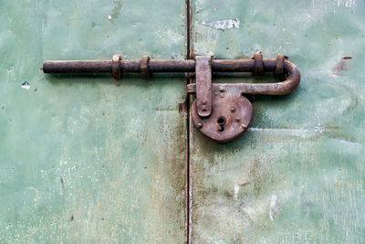 Close-up of rusty latch on metallic door