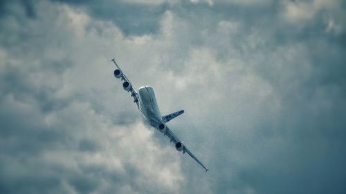 Low angle view of airplane against sky