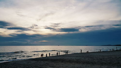 People on beach against sky