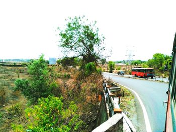 Cars on road against clear sky