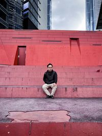 Side view of man sitting on steps