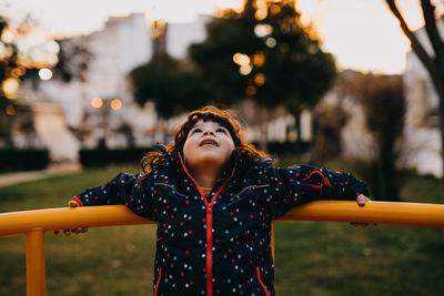 Cute girl standing by play equipment