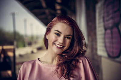 Portrait of smiling woman in city