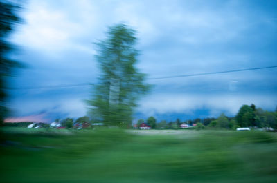 Scenic view of field against cloudy sky