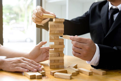 Midsection of man playing with toy on table