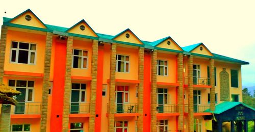 Multi colored houses in city against sky