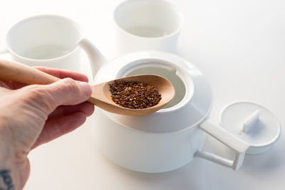 Close-up of hand holding coffee cup