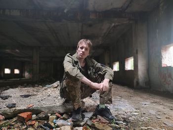 Portrait of man standing in abandoned building