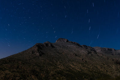 Low angle view of mountain against sky at night