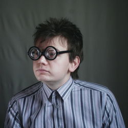 Portrait of boy wearing sunglasses against gray background