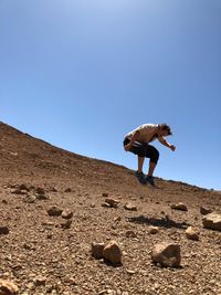 Man jumping against clear sky