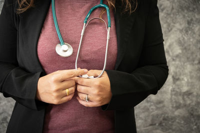 Midsection of doctor wearing stethoscope