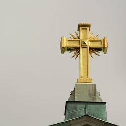 Low angle view of statue against temple against clear sky