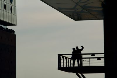 Silhouette people taking selfie at elbphilharmonie