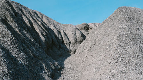 Low angle view of rock formations against sky