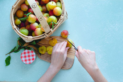High angle view of hand holding fruits in basket