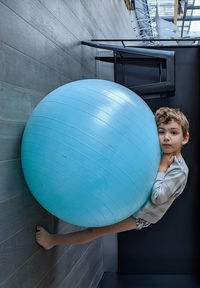 Rear view of woman holding balloons