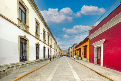 Street amidst buildings against sky in city