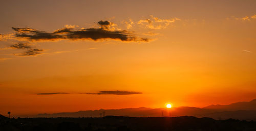 Scenic view of silhouette landscape against romantic sky at sunset