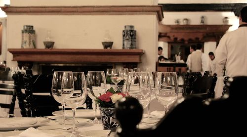 Close-up of wine glasses on table in restaurant