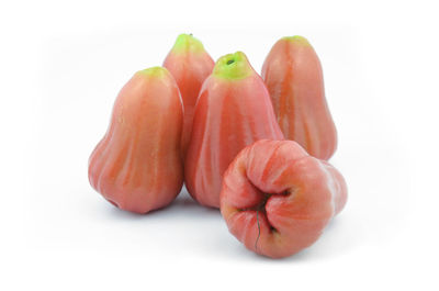 Close-up of tomatoes over white background