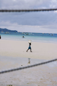 Man on beach against sky