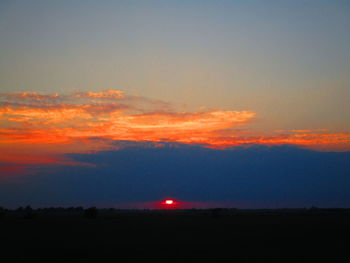 Scenic view of silhouette landscape against romantic sky at sunset