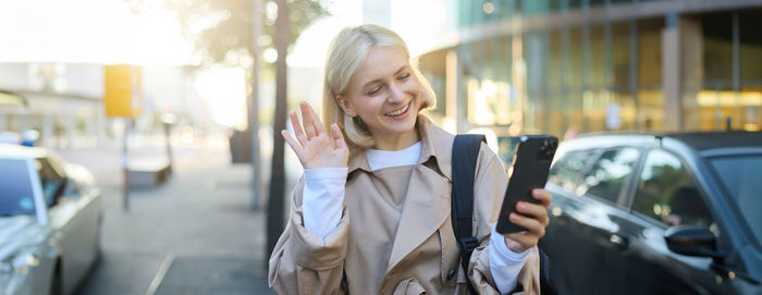 Portrait of young woman using mobile phone